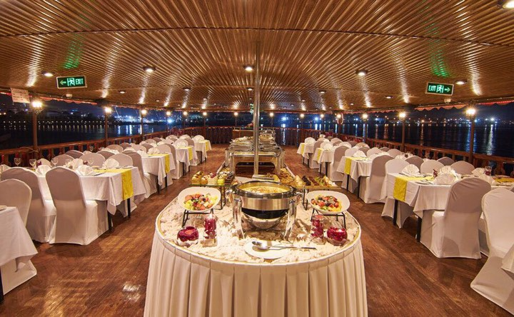 Onboard buffet dining hall set with white linens aboard the dhow